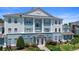 An exterior view showcases a blue and white condominium building with manicured landscaping at 7689 Heritage Crossing Way # 202, Reunion, FL 34747