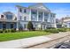 Beautiful three-story building with white columns and blue accents at 7689 Heritage Crossing Way # 202, Reunion, FL 34747