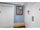 Hallway featuring unit entrance with framed art, neutral walls and a patterned bench at 7689 Heritage Crossing Way # 202, Reunion, FL 34747