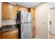 Kitchen view features stainless steel refrigerator and granite countertops at 7689 Heritage Crossing Way # 202, Reunion, FL 34747