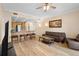 Open floor plan with modern furnishings, kitchen bar, and laminate flooring at 7689 Heritage Crossing Way # 202, Reunion, FL 34747