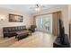 Cozy living room with modern furniture and French doors to balcony at 7689 Heritage Crossing Way # 202, Reunion, FL 34747