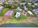 Aerial view showcasing the community's pool, tennis courts, sand volleyball and scenic lake at 833 Lockbreeze Dr, Davenport, FL 33897