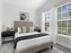 Serene bedroom with plush bedding, side tables, and ample natural light from the windows at 833 Lockbreeze Dr, Davenport, FL 33897