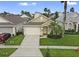Charming single-Gathering home featuring a two-car garage, landscaped yard, and welcoming front porch at 833 Lockbreeze Dr, Davenport, FL 33897