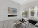 Bright living room with a modern fireplace, and views of the backyard pool at 833 Lockbreeze Dr, Davenport, FL 33897