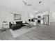 Open-concept living room showcases tile floors, modern furnishings, and views of the kitchen with stainless steel appliances at 833 Lockbreeze Dr, Davenport, FL 33897