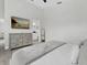 Main bedroom featuring a dresser, tv, ensuite bath, and tile floors at 833 Lockbreeze Dr, Davenport, FL 33897