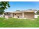 Rear view of home with a grassy yard at 845 N Ludlum Dr, Deltona, FL 32725