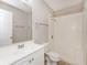 Clean bathroom featuring a white vanity, toilet, and a walk-in shower with tiled walls at 845 N Ludlum Dr, Deltona, FL 32725