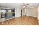 View of the open floor plan showing the kitchen with blue cabinets, stainless steel appliances, and a breakfast bar at 845 N Ludlum Dr, Deltona, FL 32725