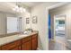Well-lit bathroom features double sinks with granite countertops, and neutral walls at 8804 Rhodes Street, Kissimmee, FL 34747