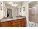This bright bathroom features double sinks, granite countertops, and a walk-in shower with glass enclosure at 8804 Rhodes Street, Kissimmee, FL 34747