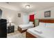 Comfortable bedroom featuring twin beds with white linens and nautical themed decor at 8804 Rhodes Street, Kissimmee, FL 34747