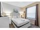 Bright bedroom with a queen bed, white linens, two side tables, and a window with blinds at 8804 Rhodes Street, Kissimmee, FL 34747