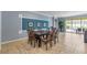 Dining area with a long dark wood table, seating for ten, and view of the pool at 8804 Rhodes Street, Kissimmee, FL 34747