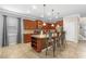 A kitchen featuring an island with granite counters, stainless steel appliances, and wood cabinets at 8804 Rhodes Street, Kissimmee, FL 34747