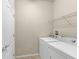 Laundry room with tile flooring, a utility shelf, and white appliances at 8804 Rhodes Street, Kissimmee, FL 34747
