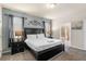 A main bedroom featuring a king-size bed, bedside tables, and an ensuite bathroom at 8804 Rhodes Street, Kissimmee, FL 34747