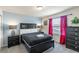 Spacious main bedroom featuring a king bed, dark wood furnishings, and bright red curtains at 8804 Rhodes Street, Kissimmee, FL 34747