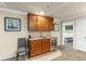 Elegant wet bar with granite countertops, wooden cabinets, and a wine cooler at 8804 Rhodes Street, Kissimmee, FL 34747