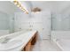 Bathroom featuring a double sink vanity, large mirrors, and a glass-enclosed shower at 912 Augusta National Blvd, Winter Springs, FL 32708