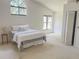 Bright bedroom with neutral carpet, two windows offering natural light, and a comfortable bed at 912 Augusta National Blvd, Winter Springs, FL 32708
