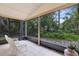 Relaxing screened patio with tiled floor and views of lush greenery, perfect for enjoying the outdoors at 912 Augusta National Blvd, Winter Springs, FL 32708
