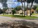 Neighborhood street featuring houses with well-manicured lawns and mature palm trees at 912 Augusta National Blvd, Winter Springs, FL 32708