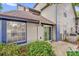 Home exterior featuring a sliding glass door and manicured landscaping at 948 Bird Bay Ct # 102, Lake Mary, FL 32746
