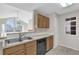 Cozy kitchen with stainless steel sink, a dishwasher, and plenty of cabinets for storage at 948 Bird Bay Ct # 102, Lake Mary, FL 32746