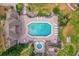 Aerial view of a luxurious community pool area featuring ample seating, a hot tub, and shade at 948 Bird Bay Ct # 102, Lake Mary, FL 32746