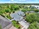 Aerial shot of the home showing the expansive lot, nearby lake, and lush landscaping at 955 Holly Springs Ter, Oviedo, FL 32765