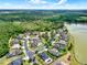 Beautiful aerial view of a suburban neighborhood with lush green landscaping, a serene lake, and well-maintained streets at 955 Holly Springs Ter, Oviedo, FL 32765