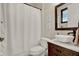 Bathroom with sink, framed mirror, toilet, and shower with white shower curtain at 955 Holly Springs Ter, Oviedo, FL 32765