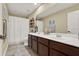 Bathroom featuring double sink vanity with dark wood cabinets, tile floors, and a shower with curtain at 955 Holly Springs Ter, Oviedo, FL 32765