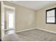 Bedroom with neutral paint, carpet, window, and white door to a bathroom or closet at 955 Holly Springs Ter, Oviedo, FL 32765