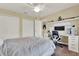 This bedroom features two closets, a ceiling fan, and a desk with shelves at 955 Holly Springs Ter, Oviedo, FL 32765