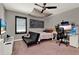 This bedroom features a futon, a TV, a ceiling fan, and a desk at 955 Holly Springs Ter, Oviedo, FL 32765