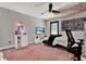 This bedroom features a futon, a TV, a ceiling fan, and desk at 955 Holly Springs Ter, Oviedo, FL 32765