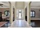 Elegant foyer with high ceilings, arched entryways, and a decorative glass front door at 955 Holly Springs Ter, Oviedo, FL 32765