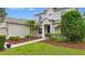 Charming home entrance with manicured landscaping, a lush lawn, and a welcoming walkway at 955 Holly Springs Ter, Oviedo, FL 32765