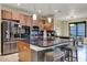 Gourmet kitchen features stainless steel appliances, granite countertops, and center island with seating at 955 Holly Springs Ter, Oviedo, FL 32765