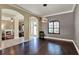 Inviting living room showcasing hardwood floors, stylish lighting, and arched entryways at 955 Holly Springs Ter, Oviedo, FL 32765