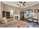 Cozy living room features a fireplace, built-in bookshelves, and comfortable seating at 955 Holly Springs Ter, Oviedo, FL 32765