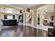Open-concept living area with hardwood floors, built-in shelving, and access to the staircase at 955 Holly Springs Ter, Oviedo, FL 32765