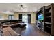 Open living room boasts hardwood floors, entertainment center, and sliding glass doors to outdoor patio at 955 Holly Springs Ter, Oviedo, FL 32765