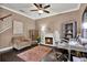 Comfortable living room includes fireplace, bookshelves, crown molding, and desk at 955 Holly Springs Ter, Oviedo, FL 32765