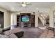 Comfortable living room featuring hardwood floors, a large entertainment center, and staircase at 955 Holly Springs Ter, Oviedo, FL 32765