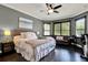 Main bedroom featuring a sitting area, bay windows, dark hardwood floors, and an ensuite bath at 955 Holly Springs Ter, Oviedo, FL 32765